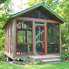 an image of a small house in the yard with red and green trimmings