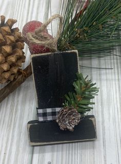 some pine cones are sitting on top of a piece of wood