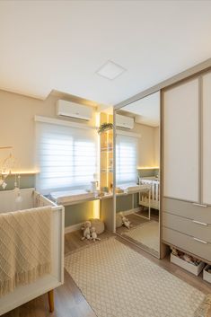 a baby's room with a crib, dresser and changing table in it