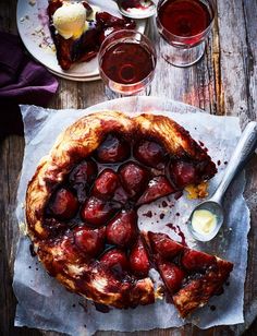 a dessert is shown on a table with wine glasses and spoons next to it