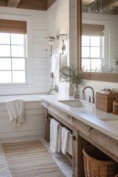 a bathroom with white walls and wood trim on the ceiling, along with two sinks