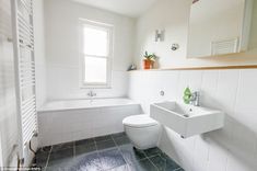 a bathroom with a toilet, sink and bathtub