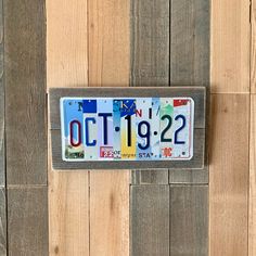 a license plate mounted to the side of a wooden wall