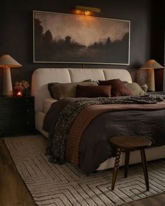 a large bed sitting in a bedroom next to two lamps