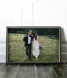 a couple standing next to each other in front of a photo frame with the word love written on it