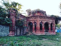 an old brick building with vines growing out of it