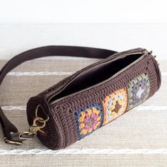 a brown purse with an embroidered design on it