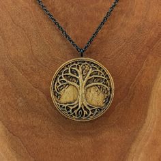 "This tree of life pendant is carved from solid maple and measures approximately 1.4\" tall x 1.4\" wide. The back can be personalized with an engraving of your choice. Up to 15 characters or less looks best. Includes an 18\" black or silver stainless steel chain. Free shipping for US customers! The item ordered comes in a cute gift bag. Items shown in the gift bag in the photo are for illustrative purposes. Every piece of wood is naturally different, the grain in your jewelry may differ slightl Engraved Brown Necklace For Gift, Natural Wood Pendant Jewelry As Gift, Natural Wood Pendant Jewelry For Gifts, Natural Wood Pendant Jewelry Gift, Natural Carved Necklaces As Gift, Spiritual Natural Wood Jewelry Gift, Engraved Natural Wood Necklace As Gift, Engraved Natural Wood Necklace For Gift, Brown Etched Jewelry As A Gift