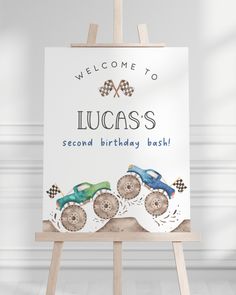 a welcome to lucas's second birthday bash sign with three toy cars on it