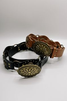 The Bianca Studded Floral Buckle Belt brings a bold statement to your style. Made from premium faux-leather, this belt is available in silver, black, or brown, offering options for any look. Featuring antiqued gold links and stud details, it adds an edge to your ensemble while maintaining a chic, feminine vibe. The standout feature is the floral detailed buckle, which adds a touch of charm to the belt’s bold design. Perfect for pairing with jeans or dresses, the Bianca belt effortlessly blends e Cool Belt Buckles, Flower Belt, Clear Purses, Faux Leather Purse, Studded Necklace, Travel Dress, Faux Leather Belts, Jumpsuit Shorts Rompers, Bar Earrings