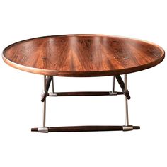 an oval wooden table with metal legs