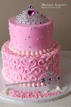 a pink cake with a tiara on top