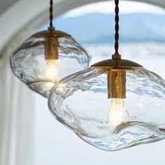 two clear glass lights hanging from a ceiling