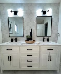 a bathroom with two sinks and mirrors on the wall