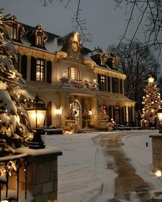 a large house with christmas lights on it's windows