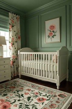 a white crib in a green room with floral curtains and pink flowers on the wall