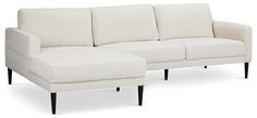 a white couch and ottoman sitting next to each other