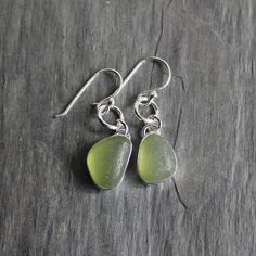 Handmade Sterling Silver Olive Green Bezel Set Sea Glass Dangly Drop EarringsNot only is it a chore to make sea glass earrings, but it is also a bigger challenge to find 2 pieces of sea glass that are similar enough to make a decently matching pair of earrings. Here are the details about these bright green earrings:I used 2 pieces of olive green sea glass from Europe set in sterling and fine silver and attached to handmade sterling silver ear wires. All of my sea glass is found and not altered i Bold Statement Necklaces, Beachglass Jewelry, Sea Glass Earrings, Jewelry Studio, Green Sea, Bubble Mailer, Glass Rings, Dainty Bracelets, Dangly Earrings