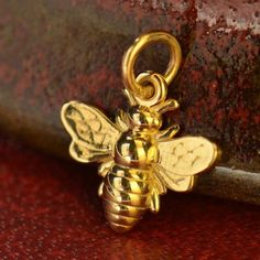 Honeybee Bumble Bee Charm. In many religions, honeybees are commonly depicted as messengers for the spirits, and are closely associated with the sun. In ancient Egypt, they're the tears of the sun-god Ra. In Hinduism we see a blue honeybee on Krishna's forehead. And, in yoga, where each chakra emits a different sound in meditation, the lowest chakra emits the hum of the honeybee. *Bronze is an alloy that consists of a mixture of copper and tin, approximately 90% copper and 10% tin. Our natural b Small Bees, Travel Charms, Bee Jewelry, Gold Bee, Bee Necklace, Silver Bead Bracelet, Monogram Jewelry, Bee Earrings, Bee Charms