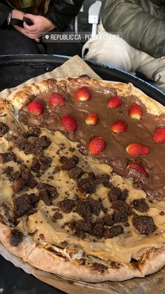 a pizza with chocolate and strawberries on it