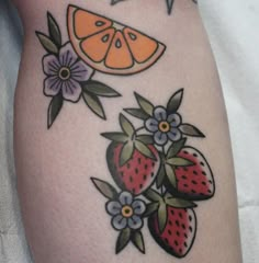 a close up of a tattoo with fruit on it