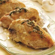 two pieces of chicken sitting on top of a plate