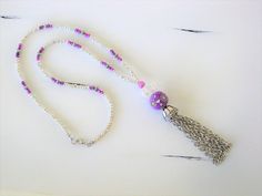 Long Silver and Purple Beaded Necklaces with Tassel handmade by Ralston Originals. These beaded necklaces come in your choice of Styles. I made the first purple tassel necklace (pictures 1 - 4) with a large purple crackle glass bead, a large antique silver metal bead on top of it, followed by a blue ceramic bead with antique silver metal bead caps surrounding it. The beaded chain is made with silver seed beads, purple seed beads, and a purple and blue bead. I made the tassel with silver metal ch Adjustable Beaded Chain Tassel Necklace As Gift, Handmade Dangle Tassel Necklace For Gift, Beaded Tassel Dangle Necklace For Gifts, Beaded Dangle Tassel Necklace For Gift, Gift Beaded Dangle Tassel Necklace, Silver Beaded Necklace, Assemblage Necklace, Beaded Tassel Necklace, Blue Beaded Necklace