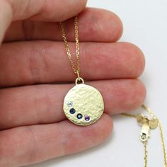 "Unique and personalized, this mother's necklace is handcrafted from 14k yellow gold and features 4 birthstones of your choice. (Price varies depending on stone combination.) Fabricated by hand using scrap 14ky gold that is melted into a chunk and hammered flat, through a process of hammering the metal to flatten it and heating the metal to soften it (annealing)....hammering and heating until the metal is 5/8\" in diameter. A hole is drilled where each stone will be set, and the surface is given Gold-colored Sterling Silver Birthstone Necklace For Birthday, Gold Sterling Silver Birthstone Necklace For Birthday, Personalized Gold Jewelry With Round Stone, Recycled Gold Silver Jewelry With Birthstone, Silver Jewelry With Birthstone In Recycled Gold, Silver Birthstone Jewelry In Recycled Gold, Fine Jewelry Yellow Gold Birthstone Necklace, 14k Gold Birthstone Necklace With Round Stone, Personalized Round Gold Birthstone Necklace