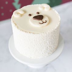 there is a white cake with a bear on it