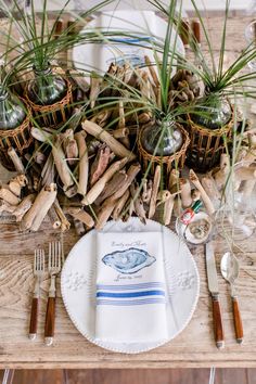 the table is set with silverware and place settings