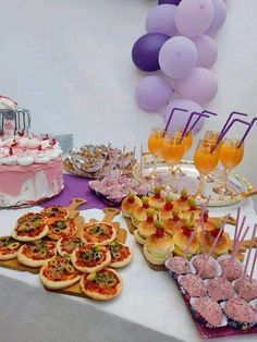 a table topped with lots of food and desserts