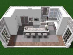 an aerial view of a kitchen and living room in a house with green grass on the ground