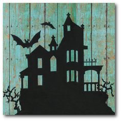 the silhouette of a house with bats flying over it on a wooden background, painted in teal and black