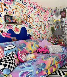 a brightly colored couch sitting in front of a colorful wall