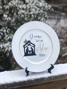 a white plate with the words i came, let us adore him on it