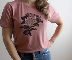 Valentine Rose Tshirt ǀ Victorian Rose Ladies Tee ǀ Graphic Floral Design Shirt SIZING: Products are unisex sizes and are a relaxed fit. You may want to order one size smaller for a fitted look. Please double check size charts available in all listings ---   Small fits sizes 4-6 Medium fits sizes 8-10 Large fits sizes 12-14 XLarge fits sizes 16-18 DETAILS: -Bella + Canvas 3001 t-shirt -Multiple color options to choose from -Crew Neck -Short Sleeve -Modern, unisex fit- -52% combed ringspun cotton -48% polyester -High quality soft fabric CARE: -Wash inside out with like colors. -Tumble dry low or hang to dry. -Do not iron directly over design. -Do not use bleach SHIPPING & PRODUCTION: -Allow 1-3 business days for production. -Allow 3-5 business days for shipping - Free Shipping in the USA on Cotton Graphic Tee With Rose Print, Rose Tshirt, Pink Rose Print T-shirt For Summer, Casual Pink T-shirt With Rose Print, Casual Pink Rose Print T-shirt, Graphic Floral, Valentines Roses, Multiple Color, Size Charts