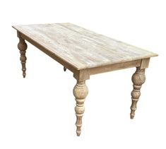 an old wooden table with turned legs on a white background is seen in this image