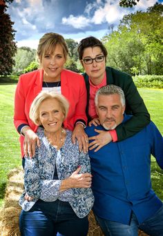 an older woman and two younger men are posing for a family photo in the park