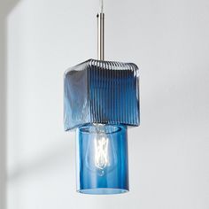 a blue glass light hanging from a ceiling