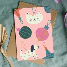 a card with a cat and dog on it next to some crafting supplies,