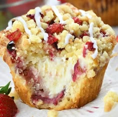 a close up of a muffin on a plate with strawberries