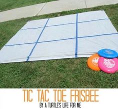 there are three frisbees laying on the ground next to a tarp