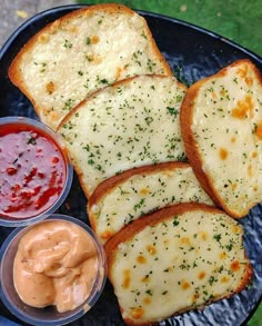 four slices of bread on a plate with sauces and mayonnaise next to it