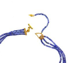 Vitality 20 Karat Yellow Gold Iolite Three-Layered Necklace Set with Diamonds. The Necklace Comes With A Toggle Clasp. All Of Our Items Are Handmade. We Believe in Craftsmanship and Originality. 1.38ct diamonds 43.65ct iolite 20K yellow gold Weight: 20.2 grams Length: 15.5 inches The Vitality Collection was inspired by Coomi’s background in textiles and love of naturalistic silhouettes. The symbolism comes through in the vines and tendrils which grow towards the light and suggest the steadfastne Elegant Tanzanite Gemstone Bead Necklaces, Elegant Tanzanite Gemstone Bead Necklace, Elegant Tanzanite Beaded Necklace, Elegant Tanzanite Jewelry With Gemstone Beads, S Background, Iolite Necklace, Layered Necklace Set, Layered Necklace, Toggle Clasp