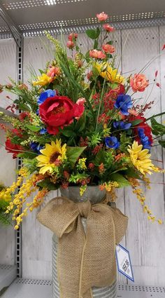 a vase filled with lots of colorful flowers