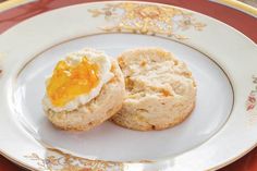 two biscuits on a plate with butter and jam