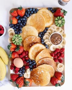 an assortment of fresh fruit and pastries on a platter