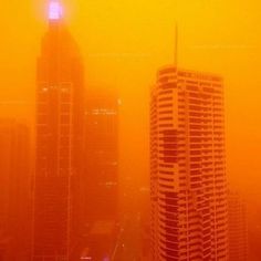 the city skyline is covered in yellow haze