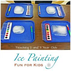 four ice painting trays on a table with pencils and watercolor paints in them