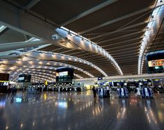 an airport terminal with people walking through it